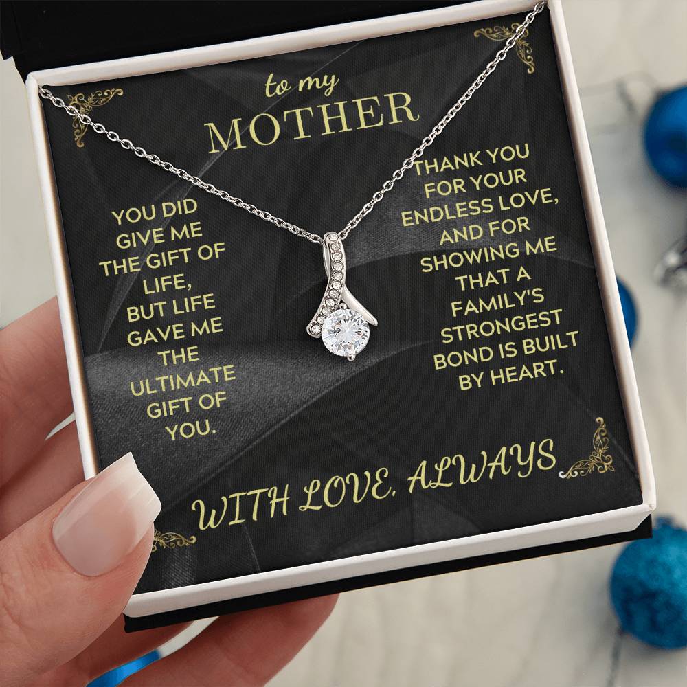 Silver-tone heart teardrop pendant necklace with rhinestone details and link chain on box insert