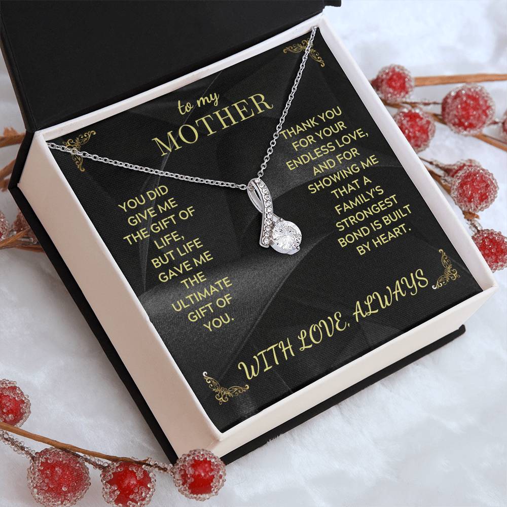 Silver-tone teardrop pendant necklace with rhinestone cluster in open white gift box