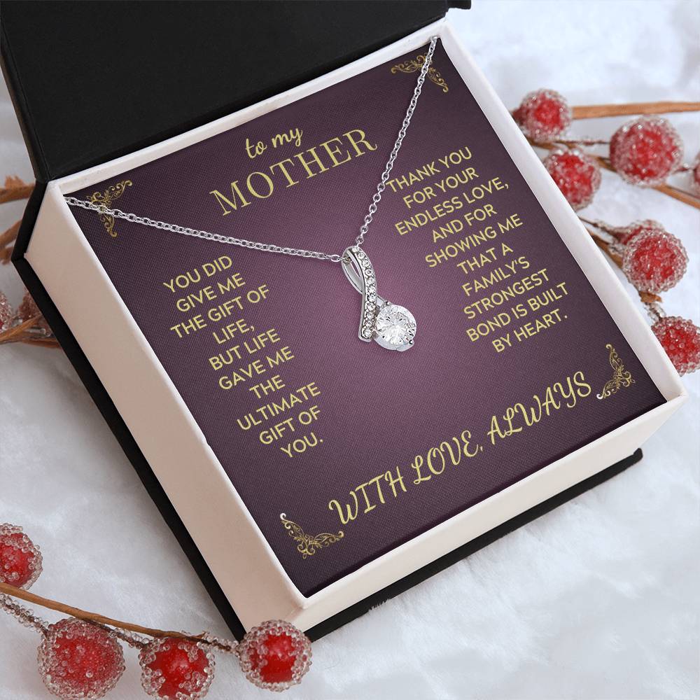 Silver-tone teardrop heart pendant necklace in white gift box on purple insert
