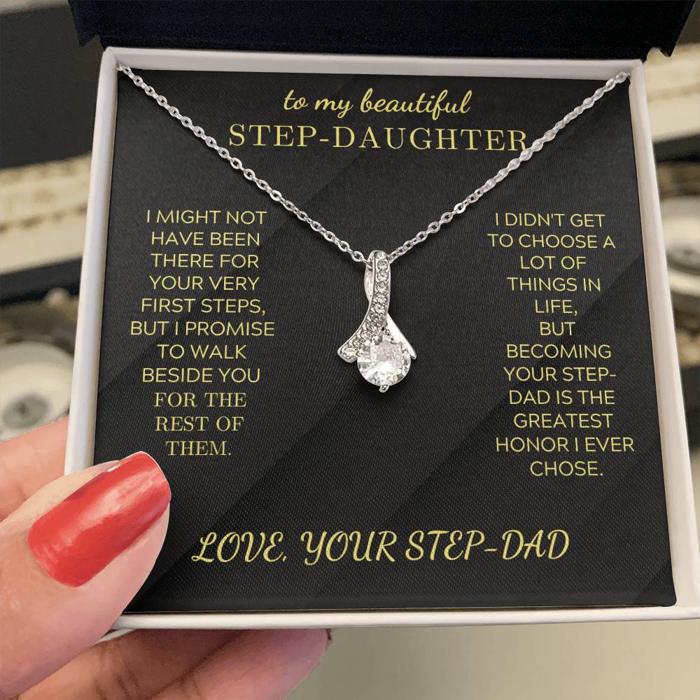 Silver-tone teardrop crystal pendant necklace in open gift box, held by hand.