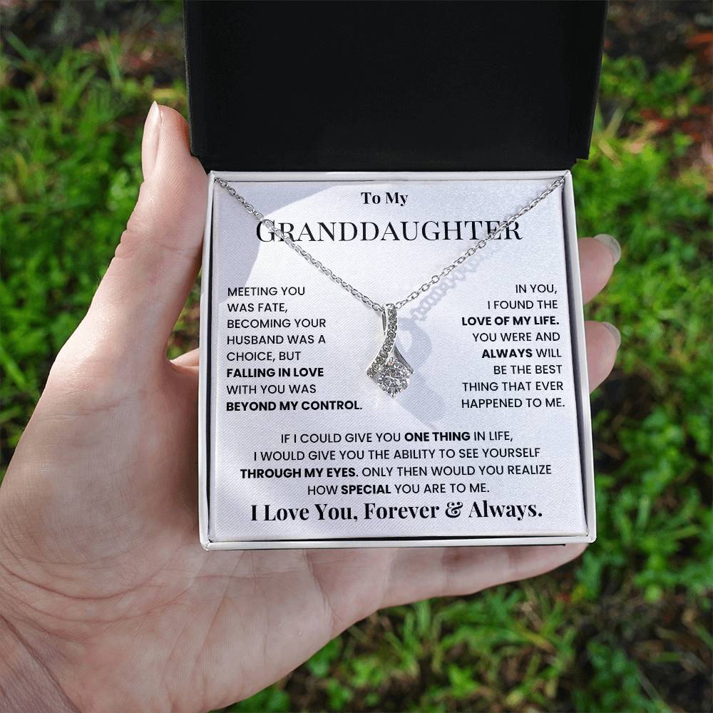 Necklace with teardrop crystal pendant displayed in message gift box held in hand