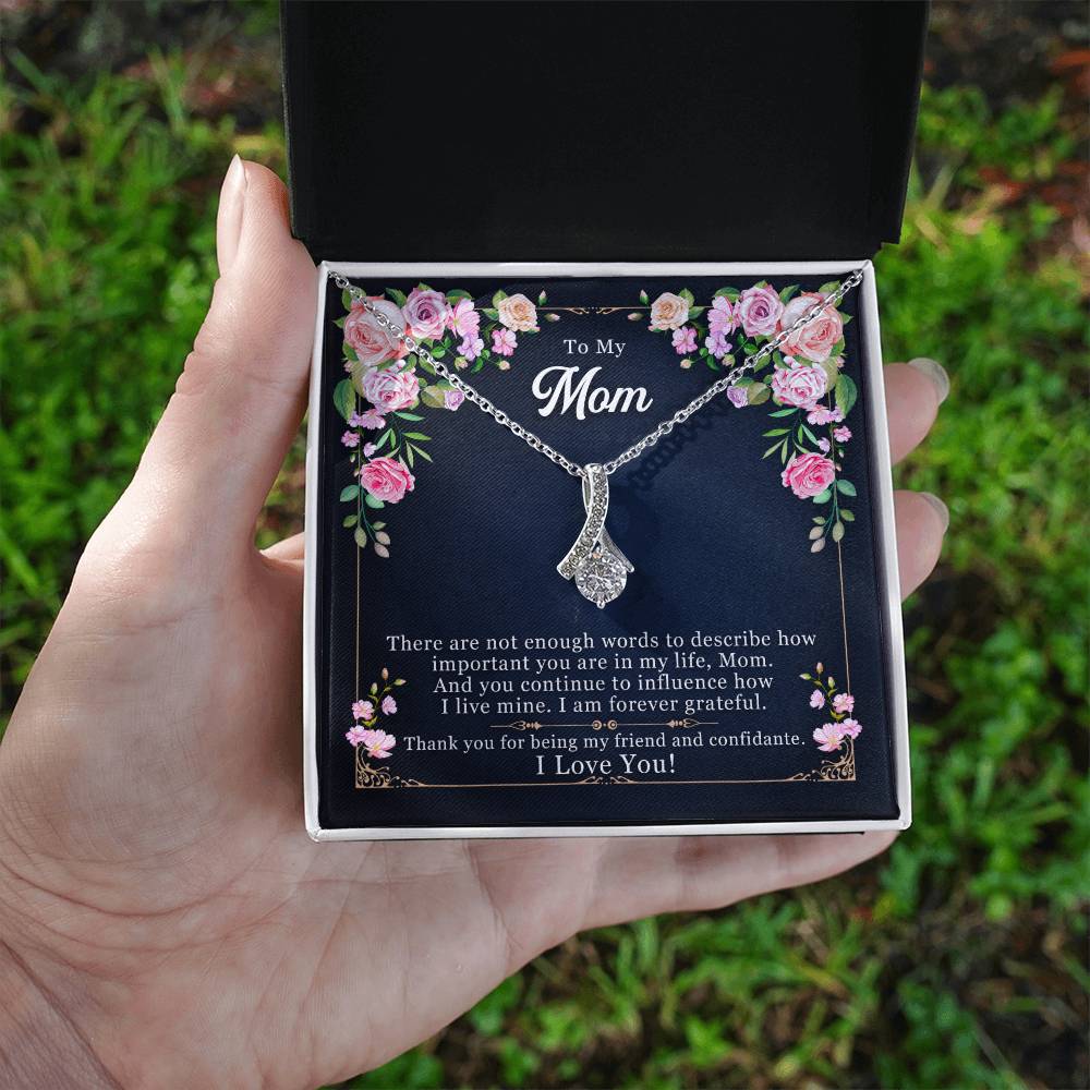 Silver-tone mom pendant necklace shown in open gift box held in hand