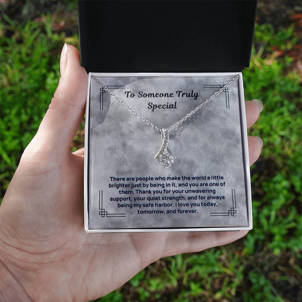 Silver-tone necklace with small teardrop crystal pendant on a fine chain