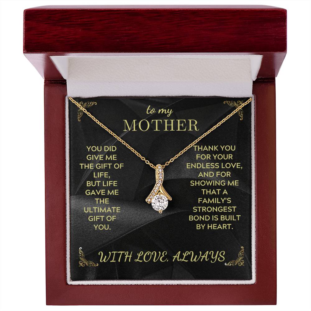 Gold-tone teardrop pendant necklace with rhinestones and link chain in red jewelry box