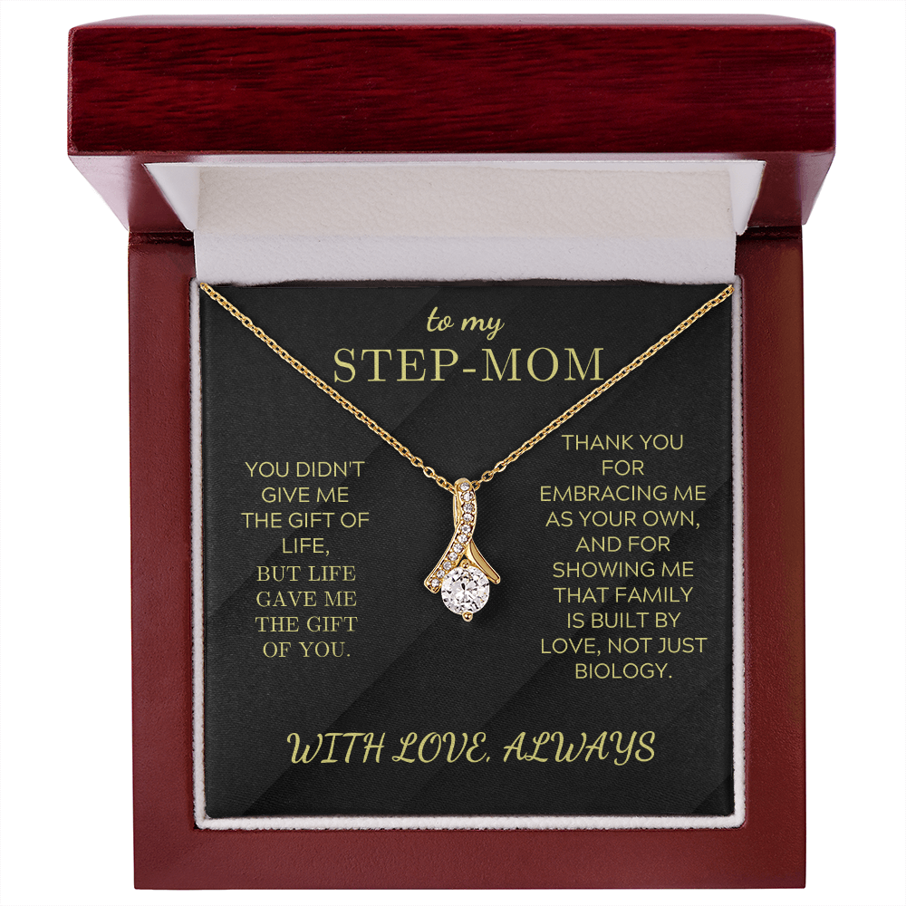 Gold-toned necklace with teardrop pendant framed by clear stones, in gift box