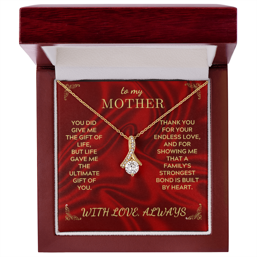 Gold-tone necklace with teardrop crystal heart pendant in red wooden-style gift box