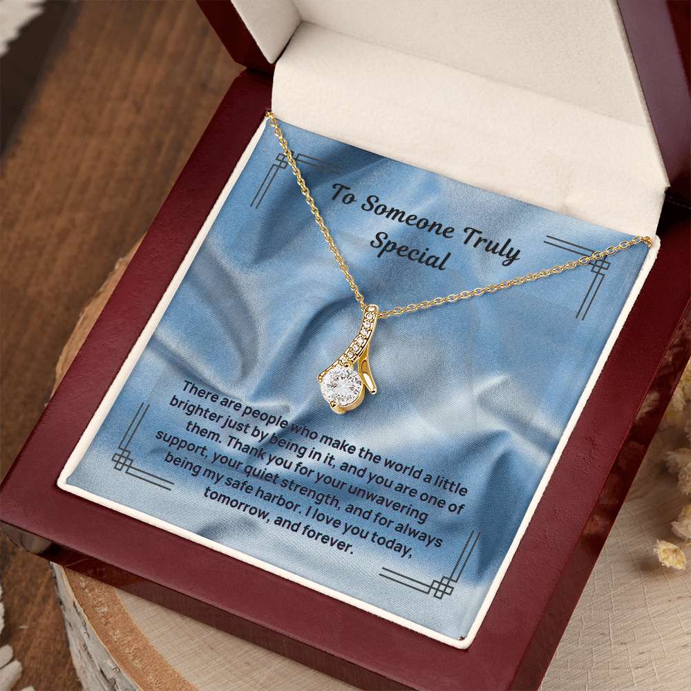Gold-tone teardrop pendant necklace with blue message card in red gift box