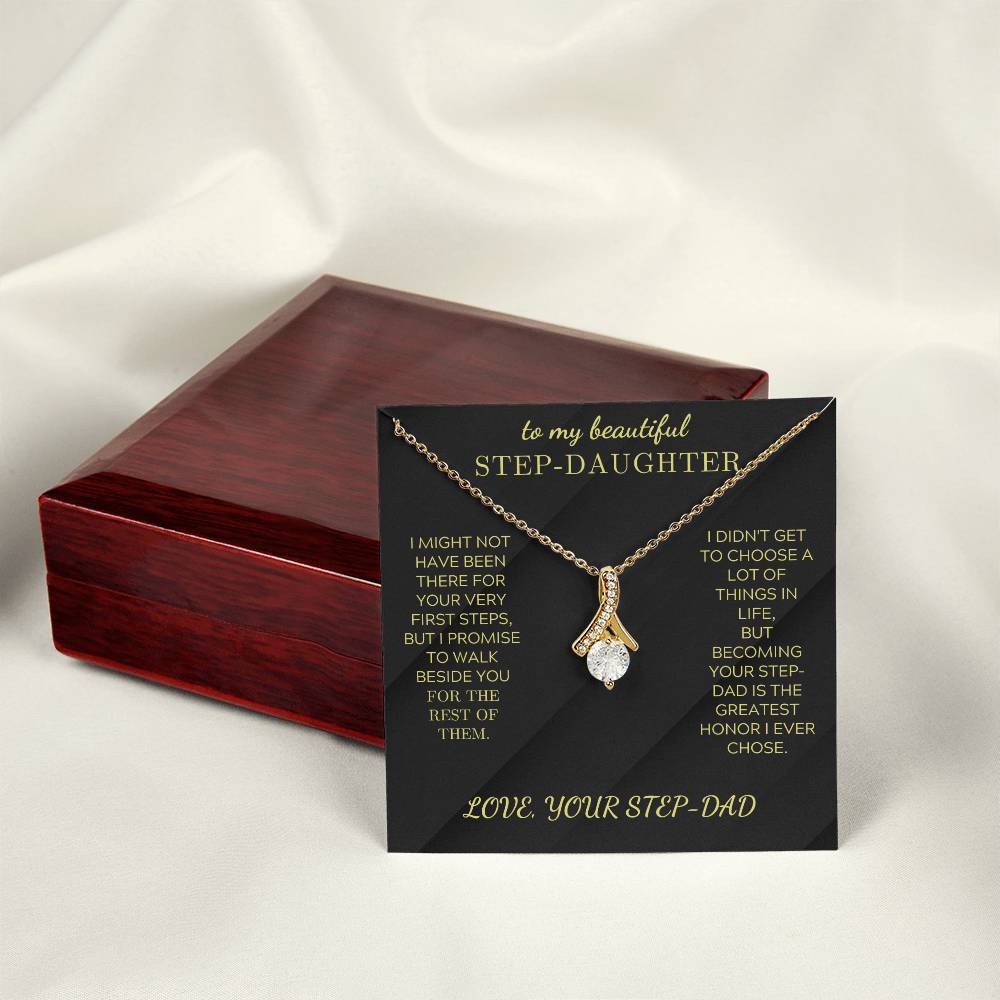 Gold-tone necklace with teardrop crystal charm on black gift box