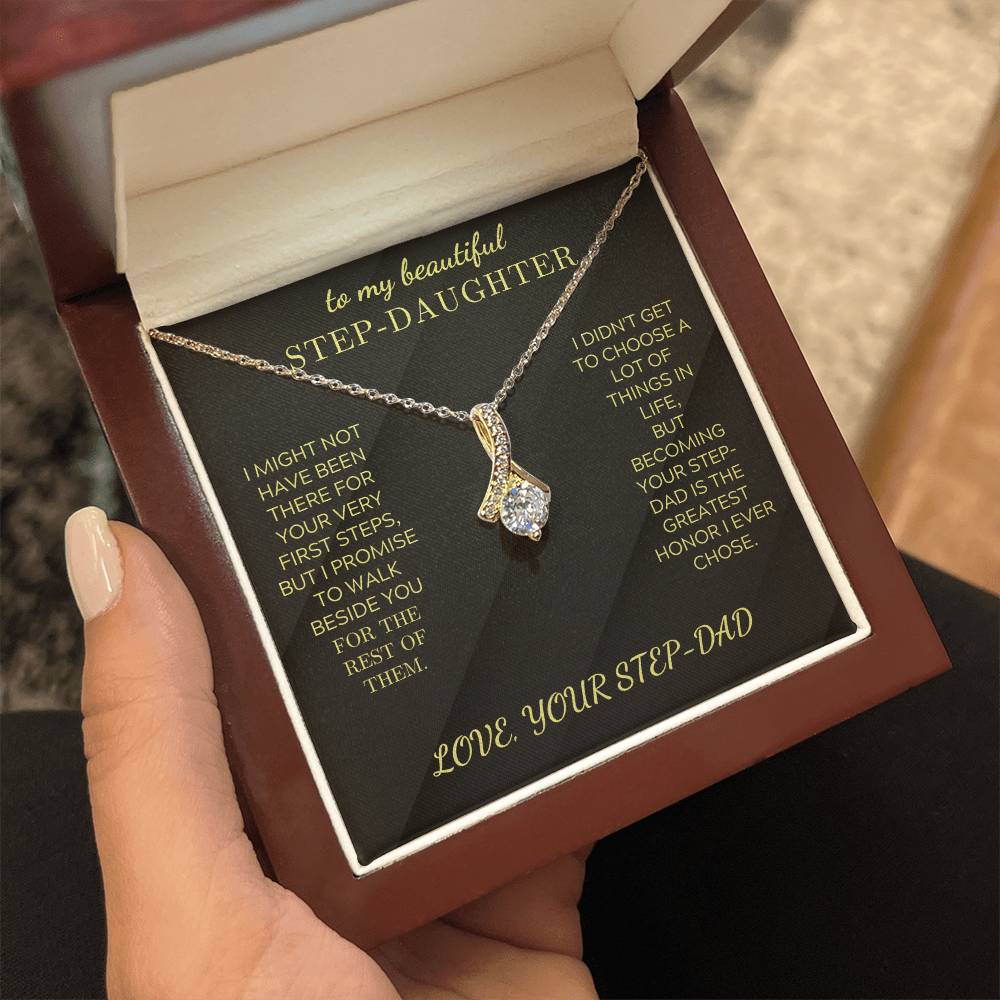 Gold-tone necklace with teardrop crystal charm on black insert box