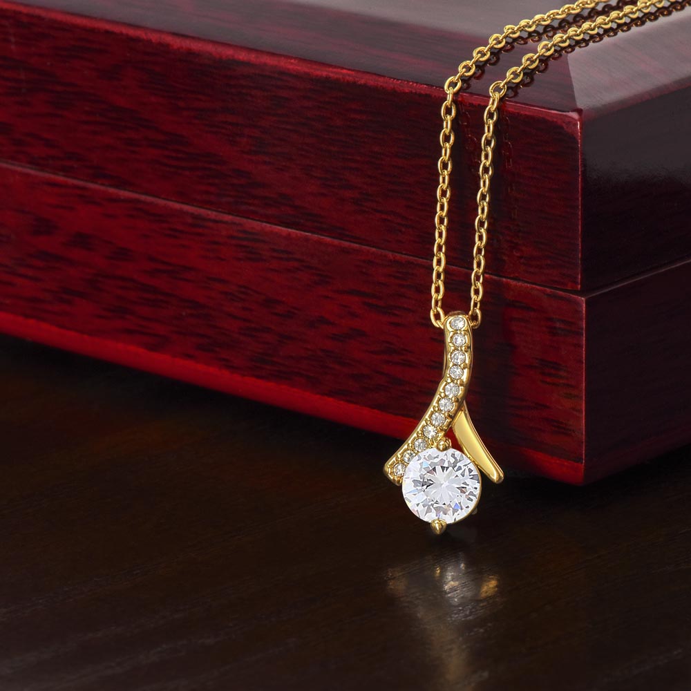 Gold-tone necklace with teardrop crystal pendant on chain