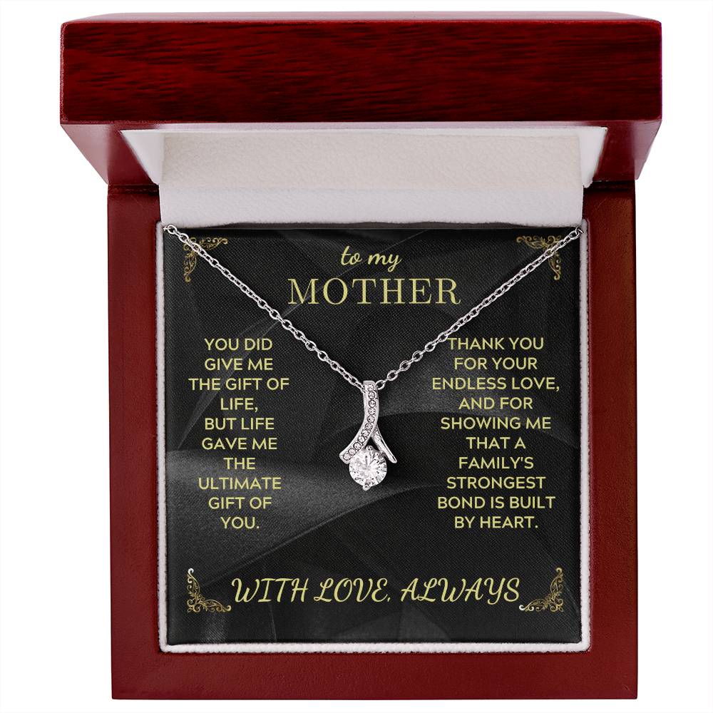 Silver-tone teardrop pendant necklace with rhinestone cluster displayed in red jewelry box