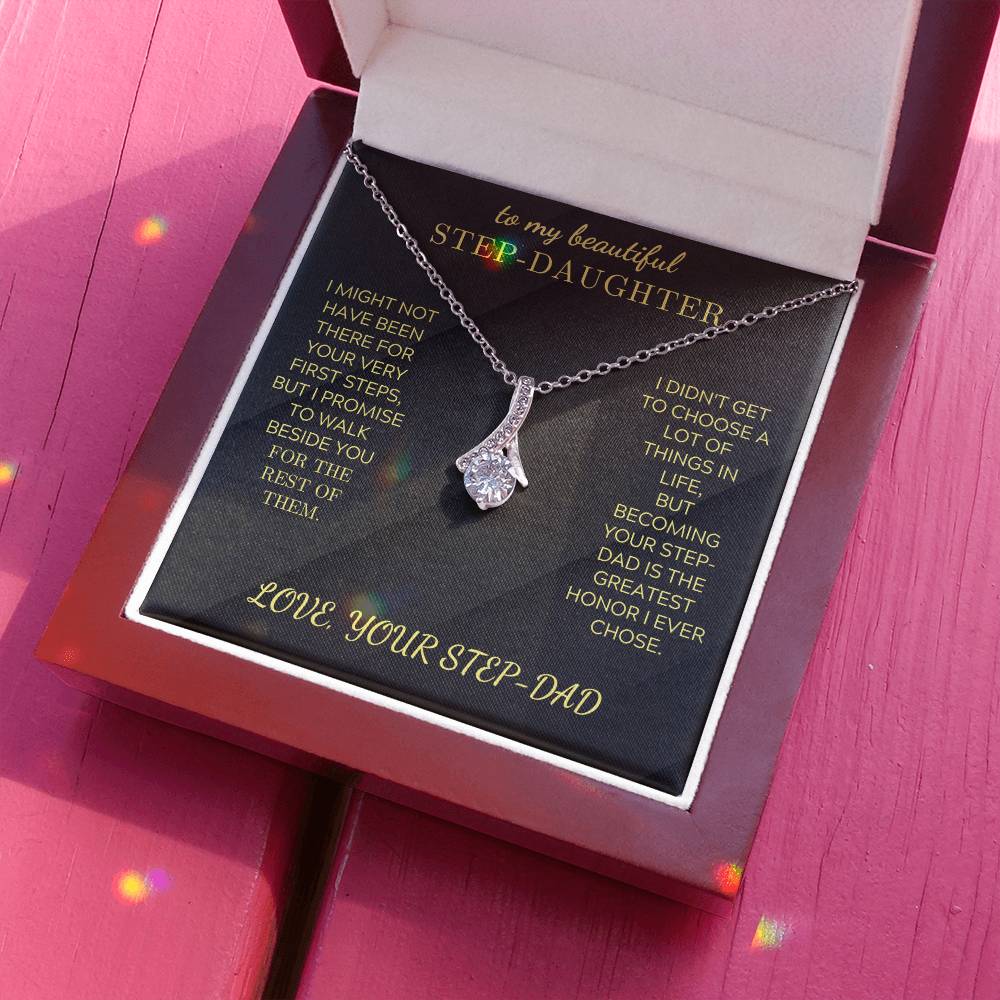 Silver-tone pendant necklace with teardrop cluster charm on a black card in box
