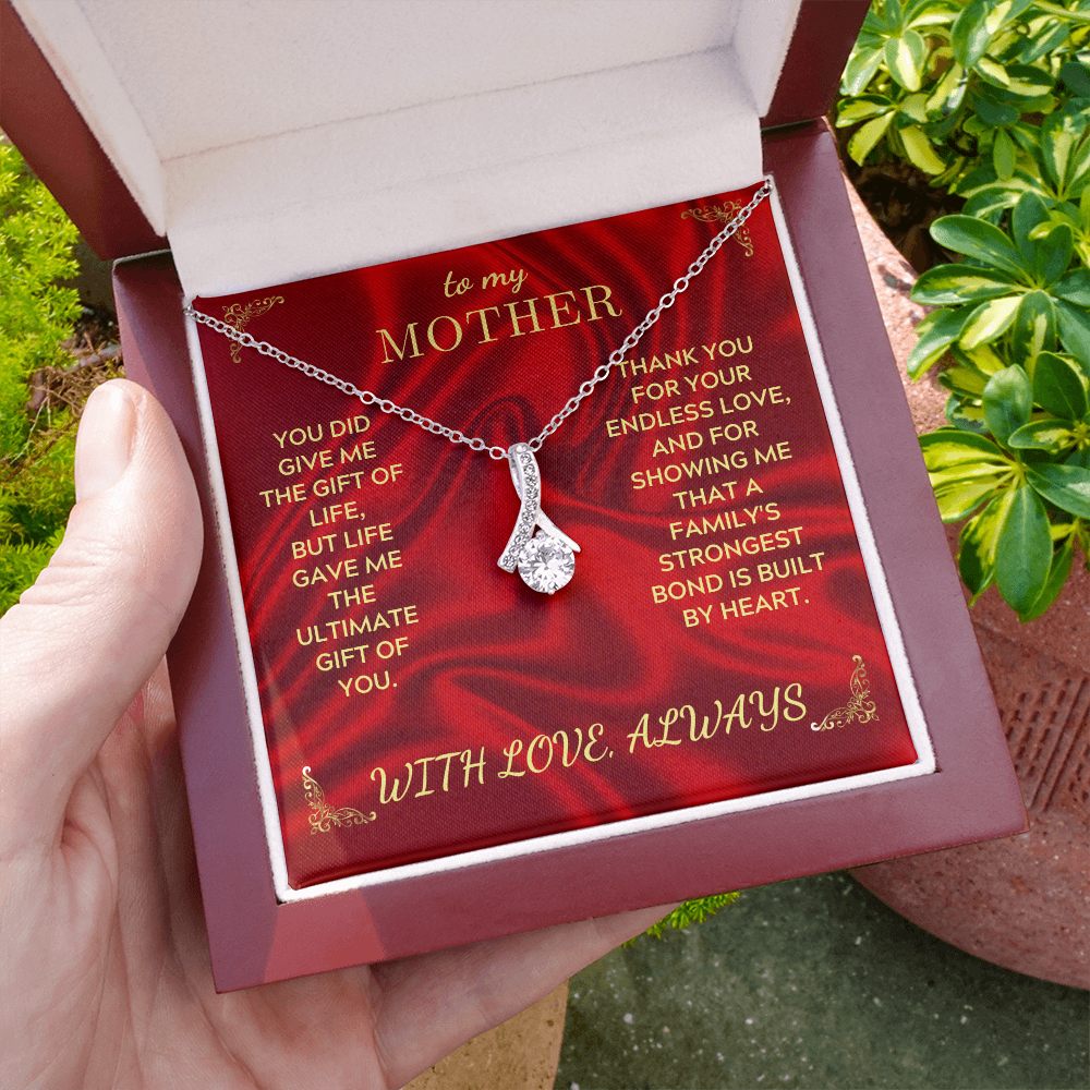Red gift box necklace with silver chain and teardrop heart pendant on red card