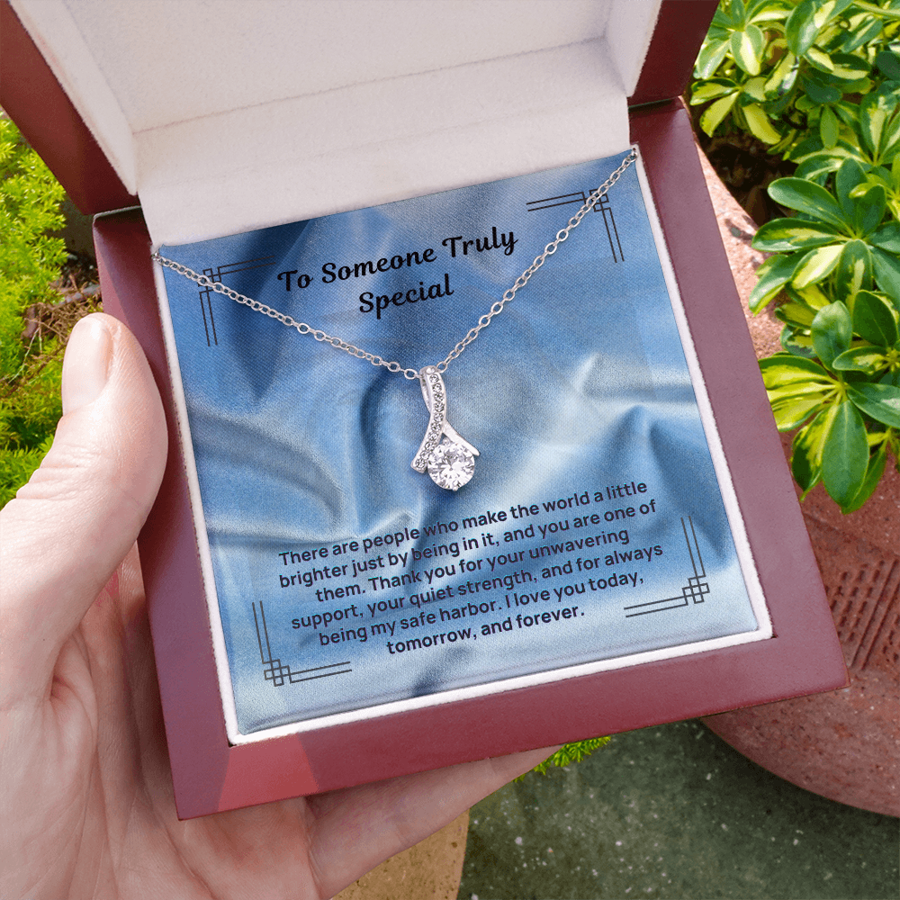 Silver teardrop pendant necklace with dangling round stone on a chain
