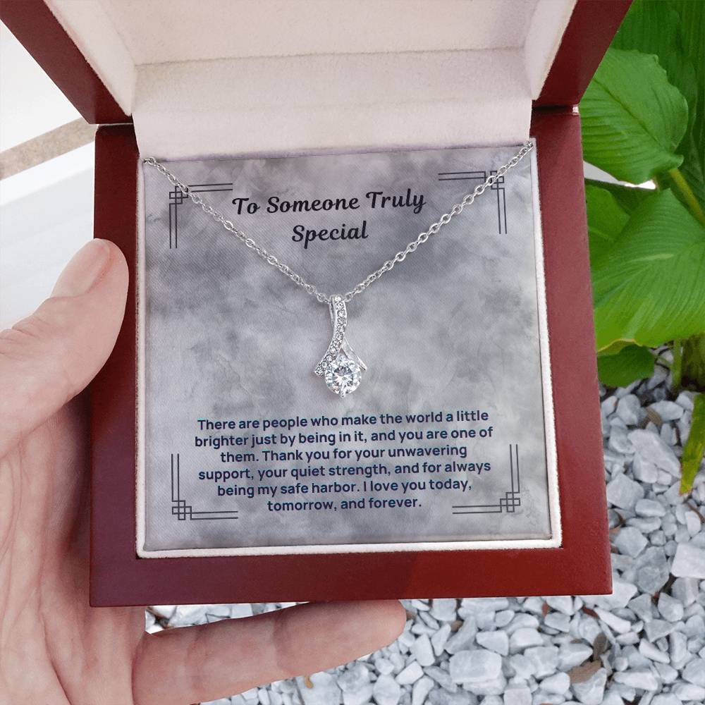 Silver-tone teardrop crystal pendant necklace in a brown open gift box