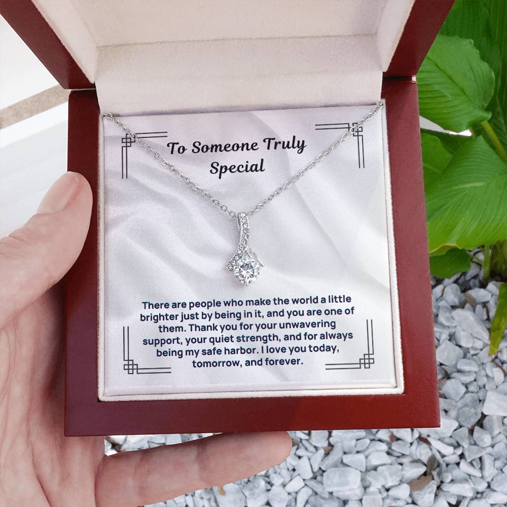 Silver-tone necklace with teardrop crystal pendant in open gift box