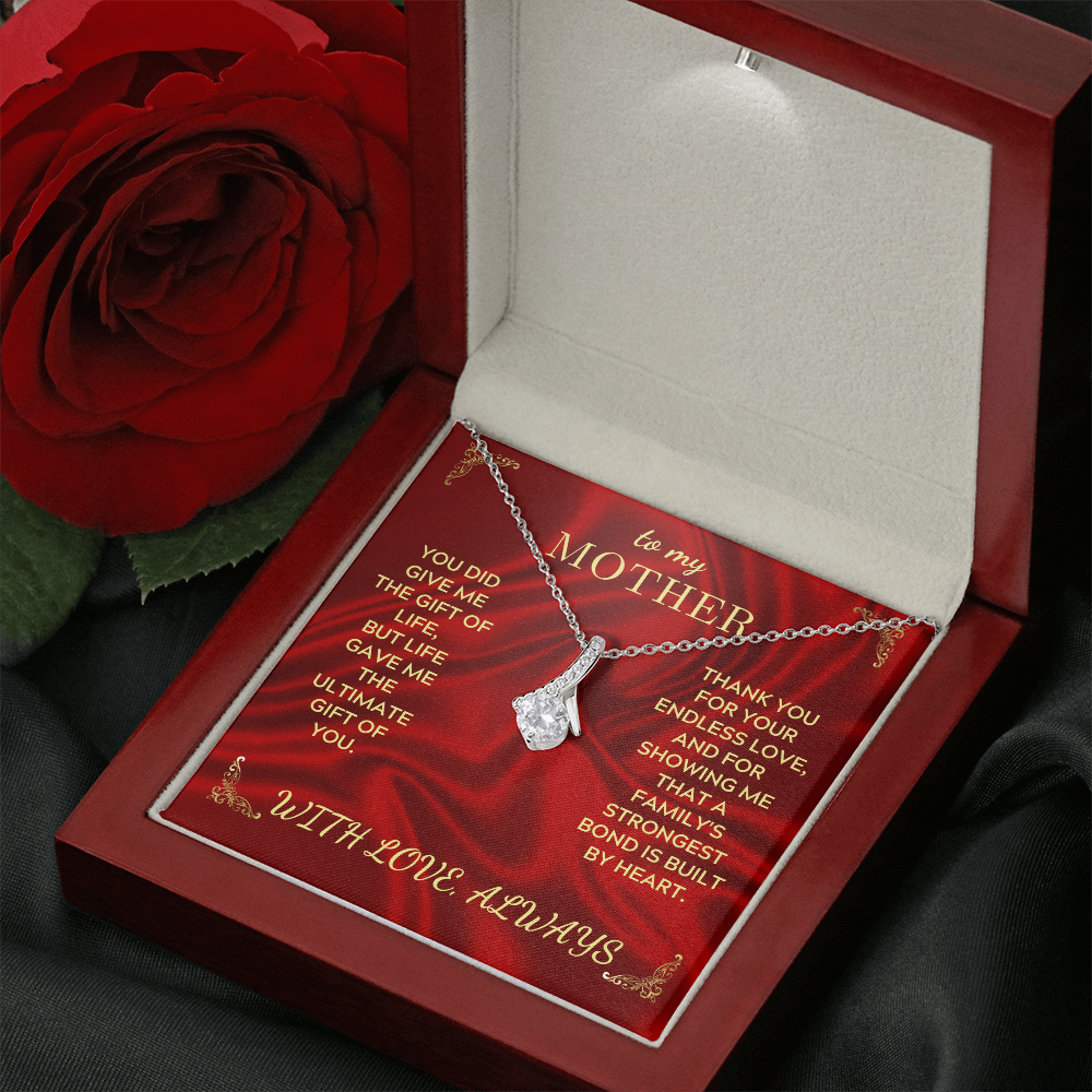Necklace inside red gift box with silver chain and teardrop heart pendant