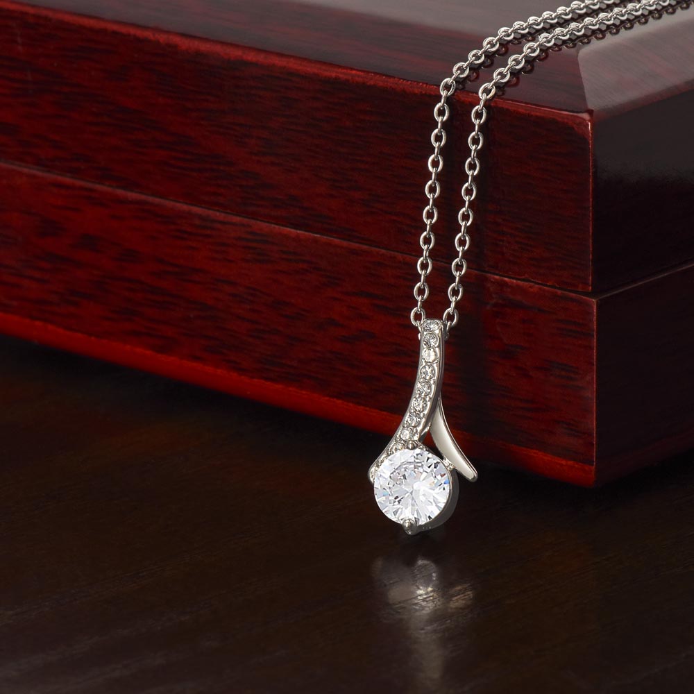 Silver-toned necklace with teardrop pendant and clear stone centerpiece