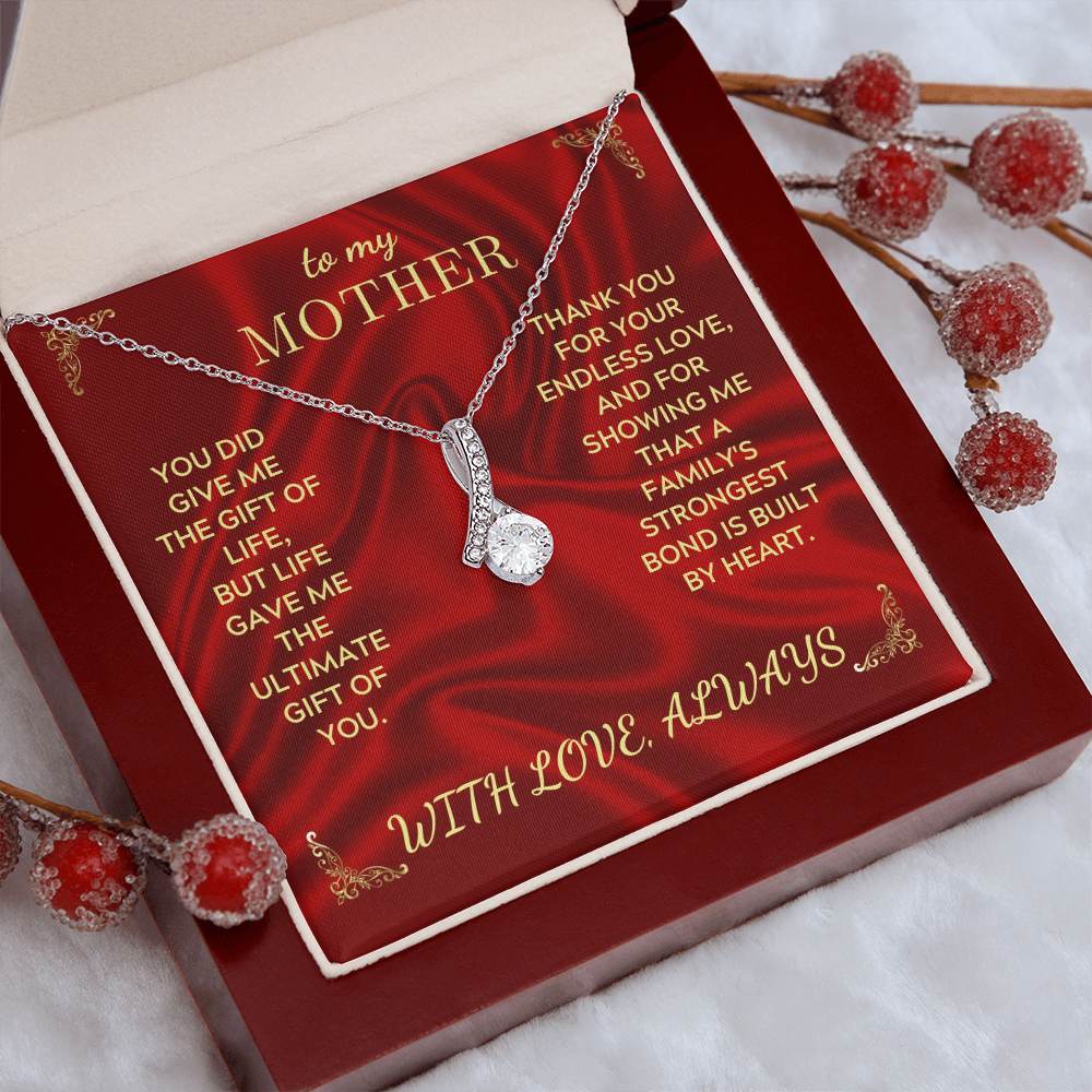 Silver necklace with teardrop heart pendant displayed in red gift box