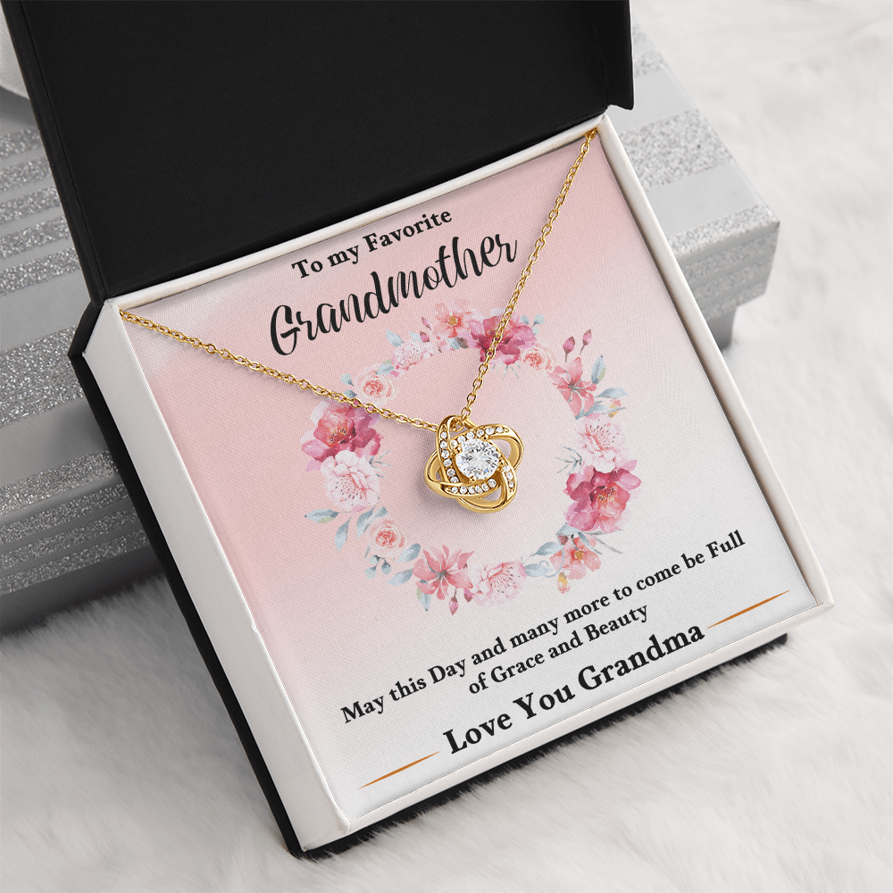 Gold love-knot pendant necklace in pink floral keepsake box, angled