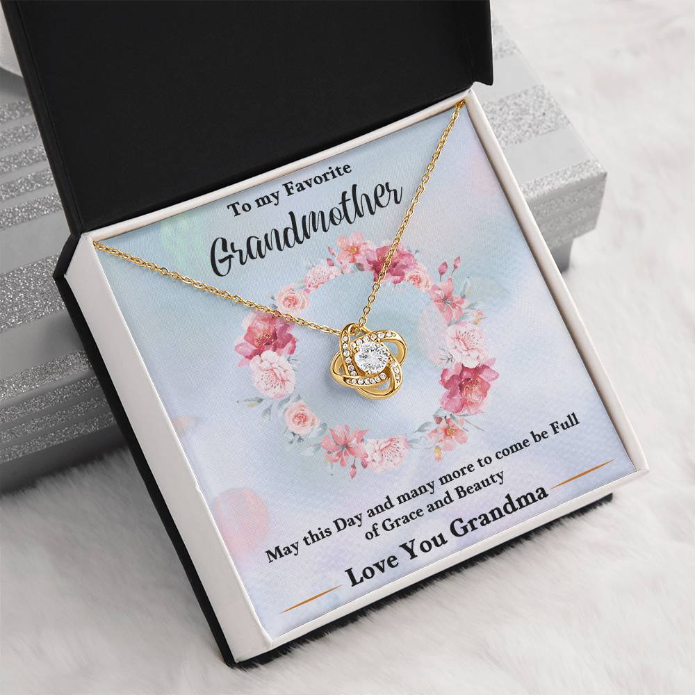 Gold-tone heart love knot necklace pendant with chain inside a gift box