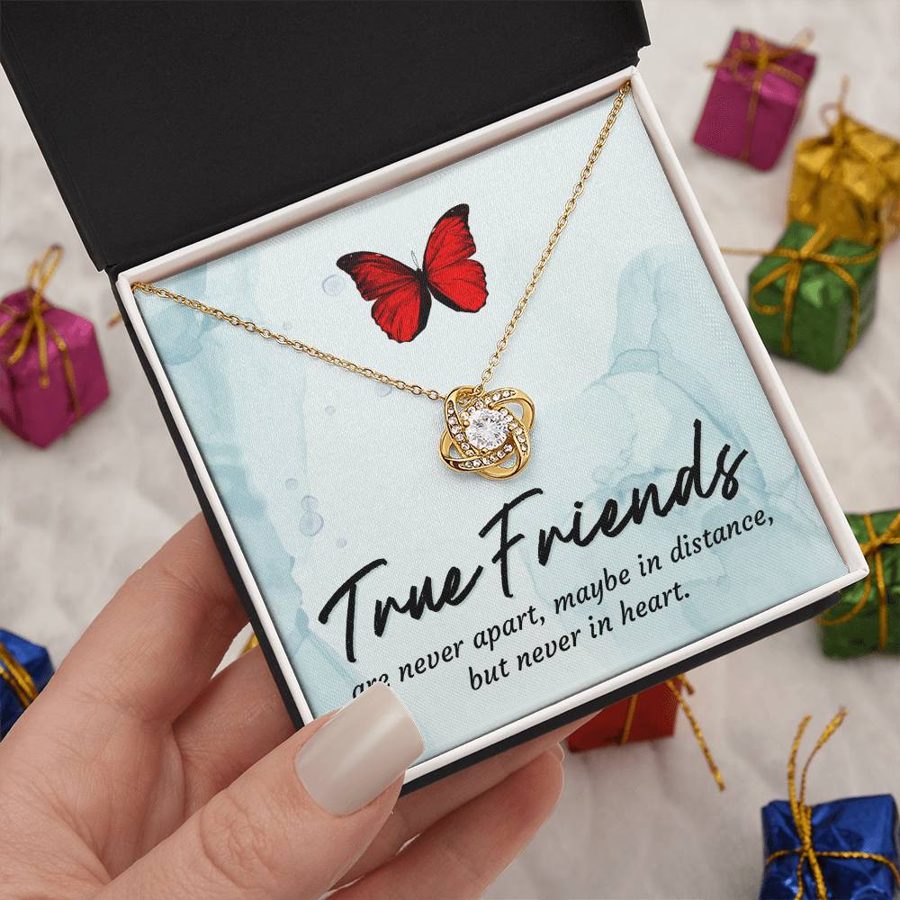 Gold love knot necklace with red butterfly pendant in open gift box