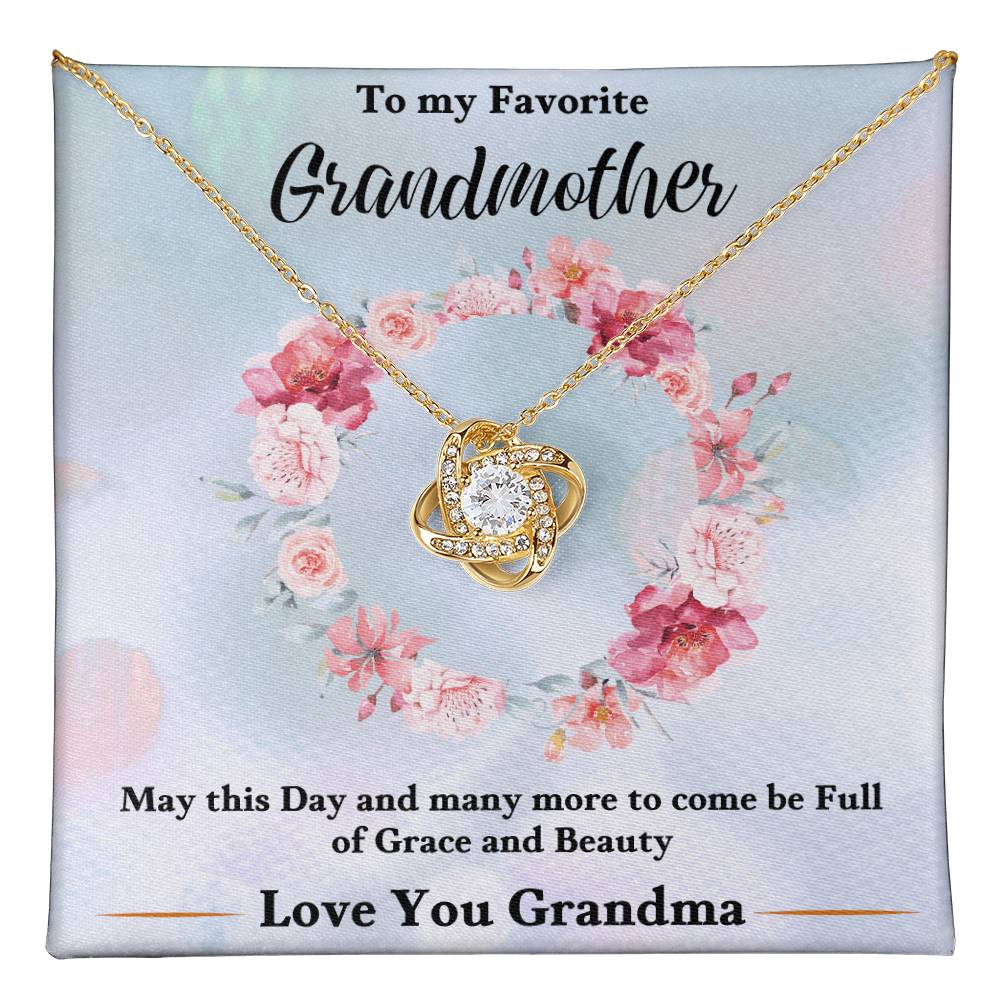 Gold heart knot pendant necklace on a floral gift card