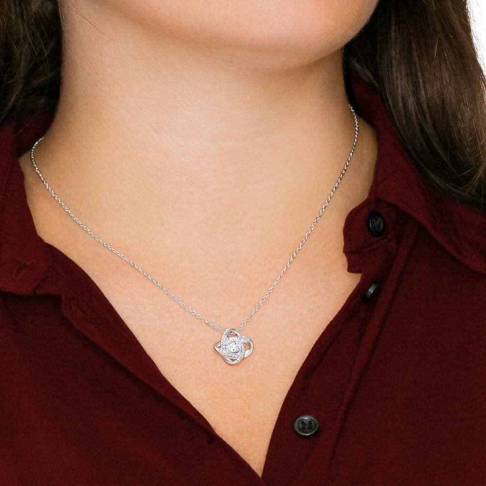 Silver-tone chain necklace with heart-shaped pendant at the collar