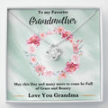 Silver heart-shaped love knot necklace with rhinestone pendant on a gift card