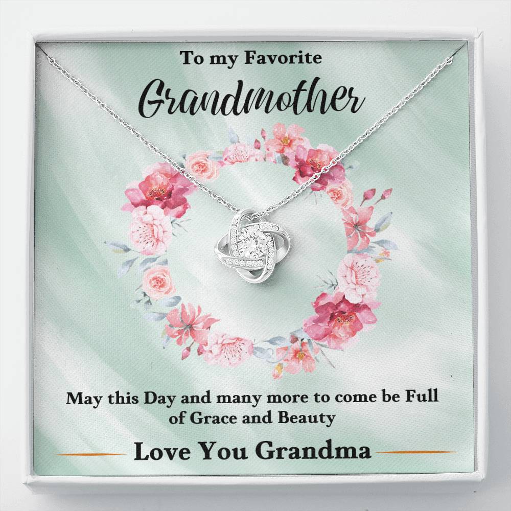 Silver heart-shaped love knot necklace with rhinestone pendant on a gift card