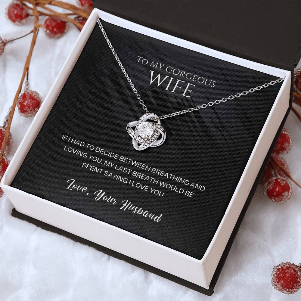 Silver-tone heart pendant necklace with round stone accents, presented in a gift box