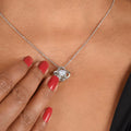 Love knot heart pendant necklace with clear-stone knot, silver chain close-up