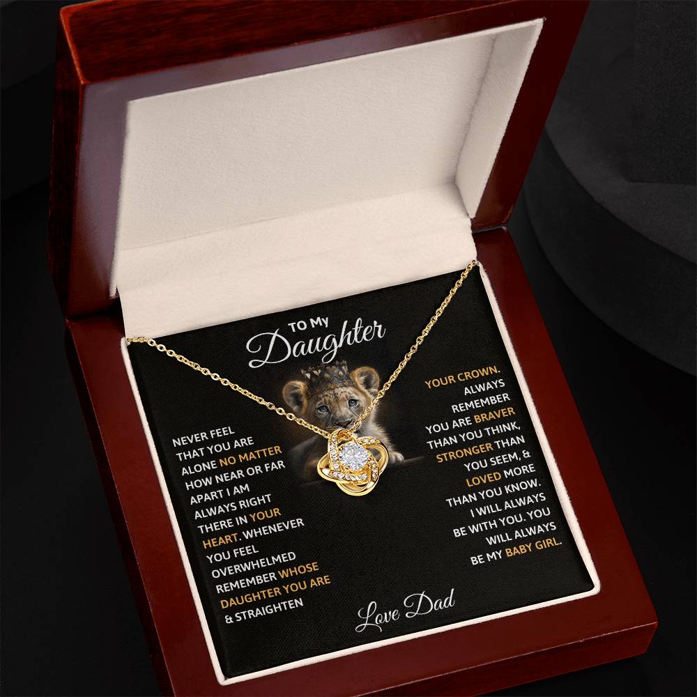 Gold-tone crown pendant necklace in open red gift box with chain and charm