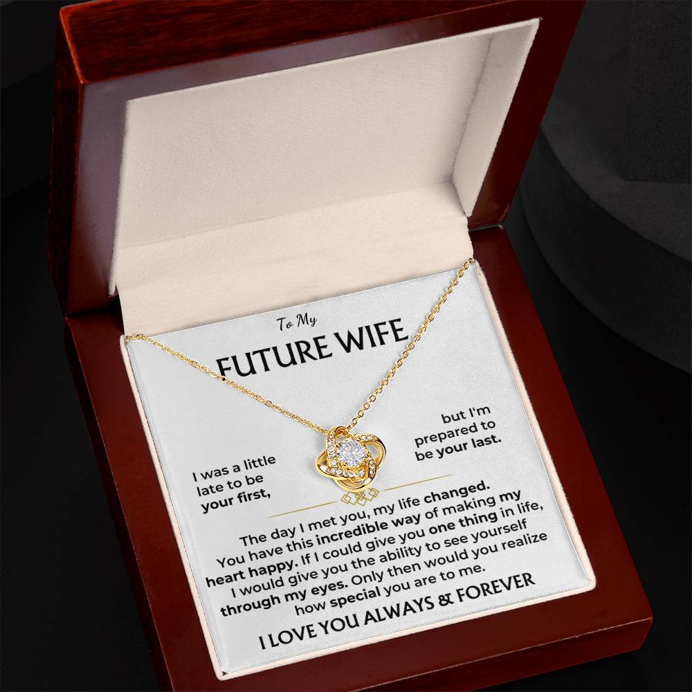Gold-tone heart pendant necklace in open “Future Wife” gift box on wooden base