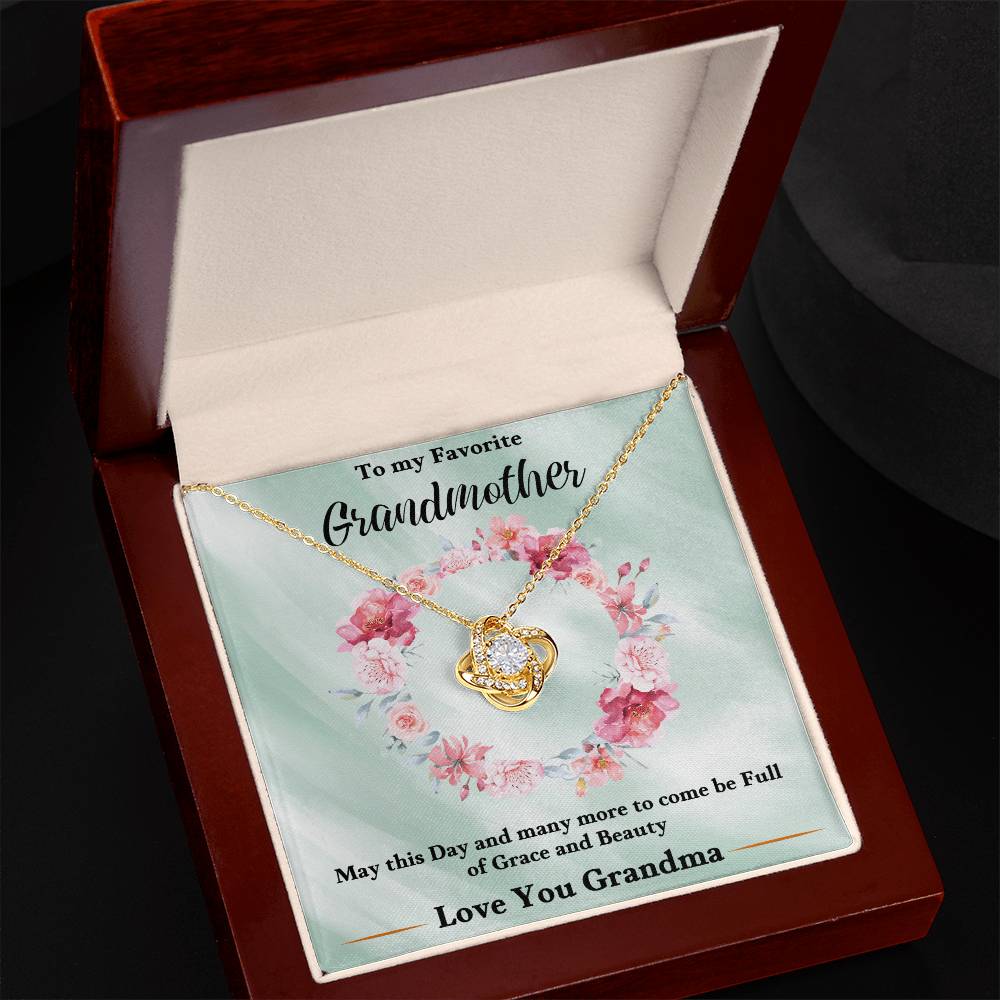 Gold love-knot heart pendant necklace with chain, displayed in a gift box