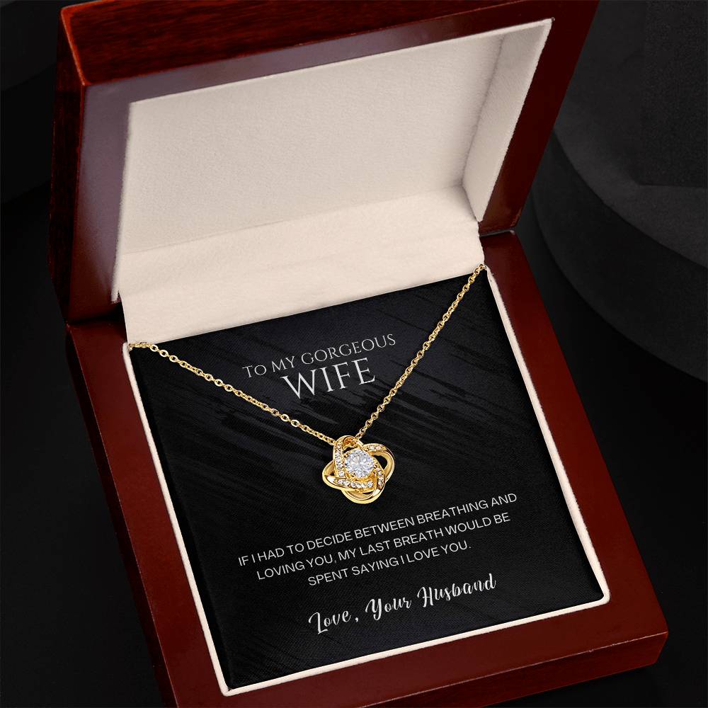Gold-tone heart pendant necklace in an opened red gift box with black insert