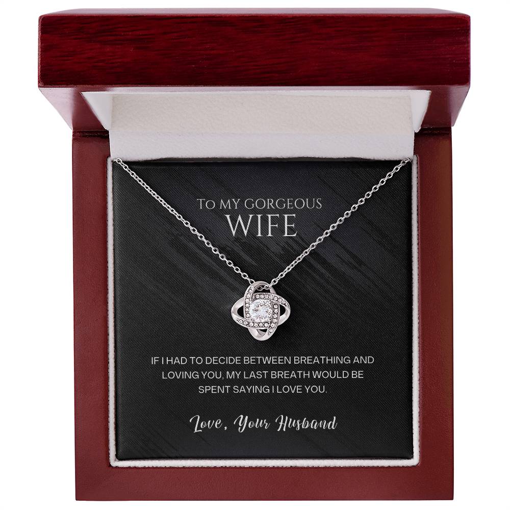 Silver-tone heart pendant necklace in a red gift box, chain draped on black insert