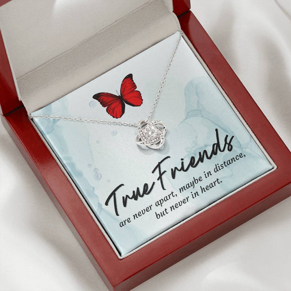 Silver love knot pendant necklace with red butterfly shown in box