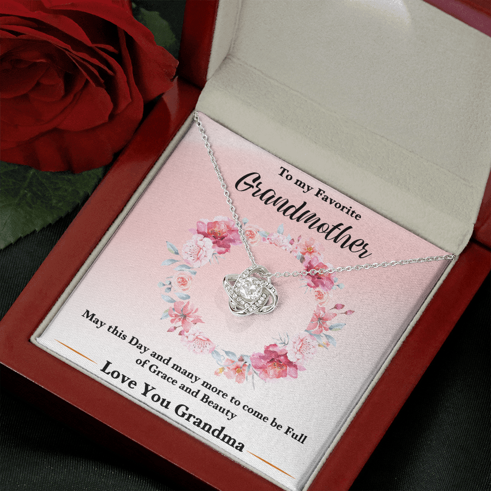 Silver love-knot pendant necklace resting in pink floral keepsake box