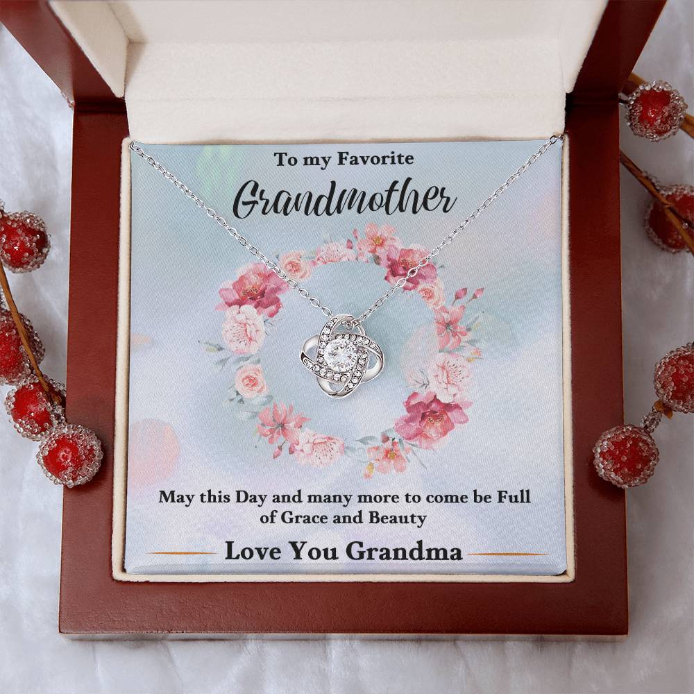 Silver heart knot pendant necklace in gift box with floral accents