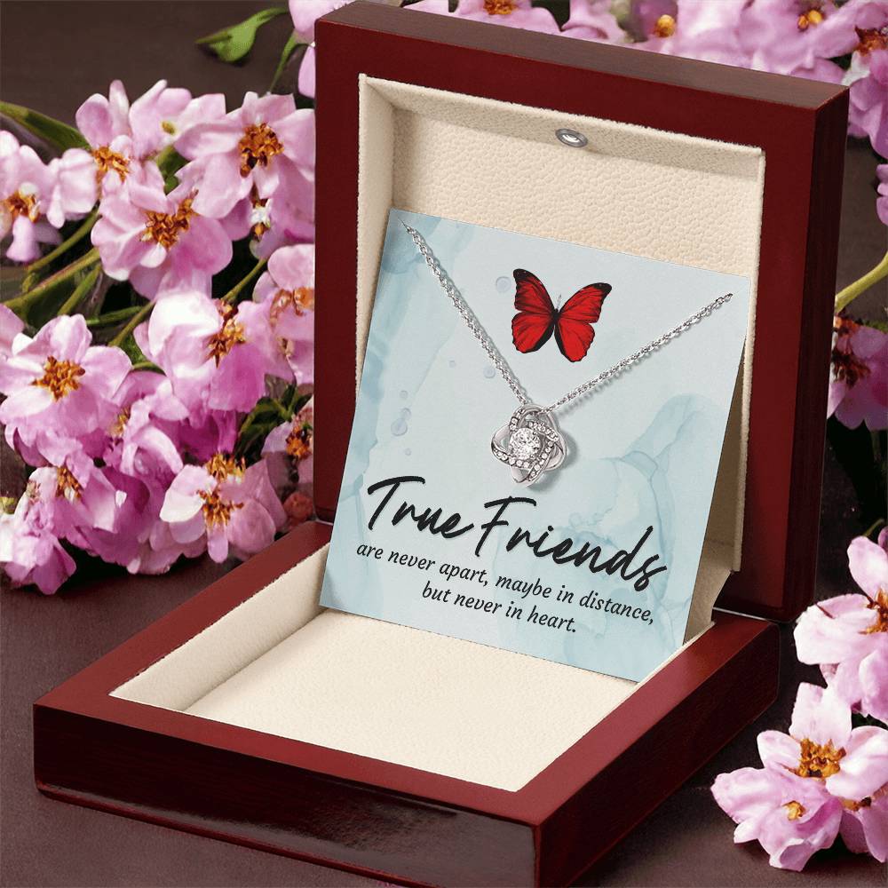Silver love knot necklace with red butterfly pendant displayed in open box