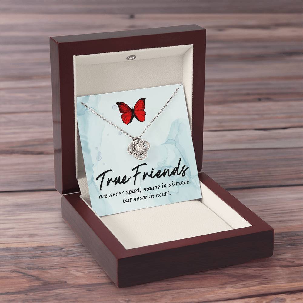 Silver love knot necklace with red butterfly pendant in closed gift box