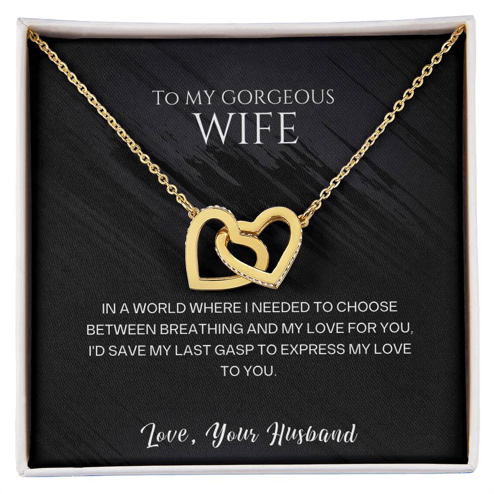 Gold-tone heart pendant necklace displayed in a black-lined gift box.