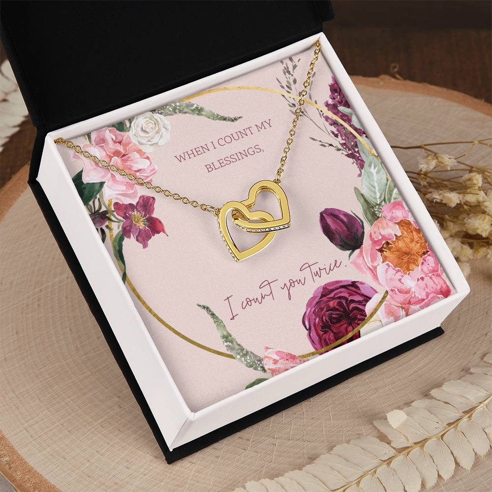 Heart pendant necklace with gold-tone finish and floral card backing in box