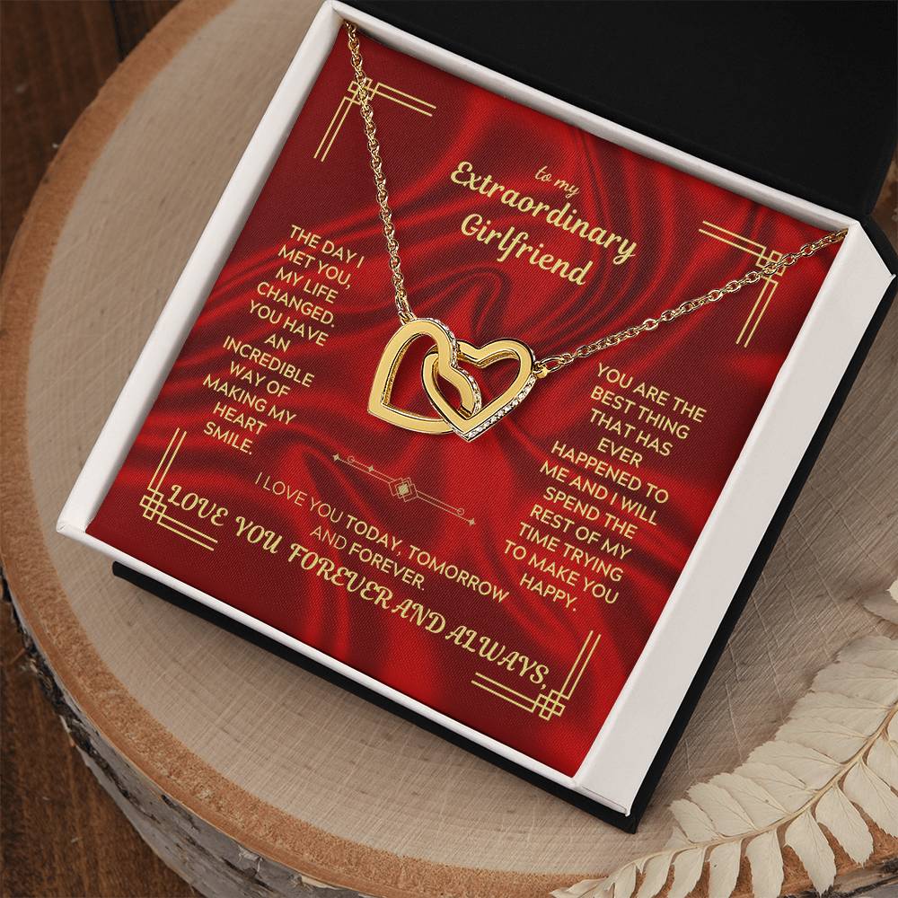 Interlocking heart necklace pendant on chain inside red gift box