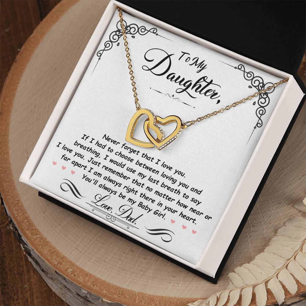 Gold-tone heart pendant necklace with two-tone heart charm in an open gift box