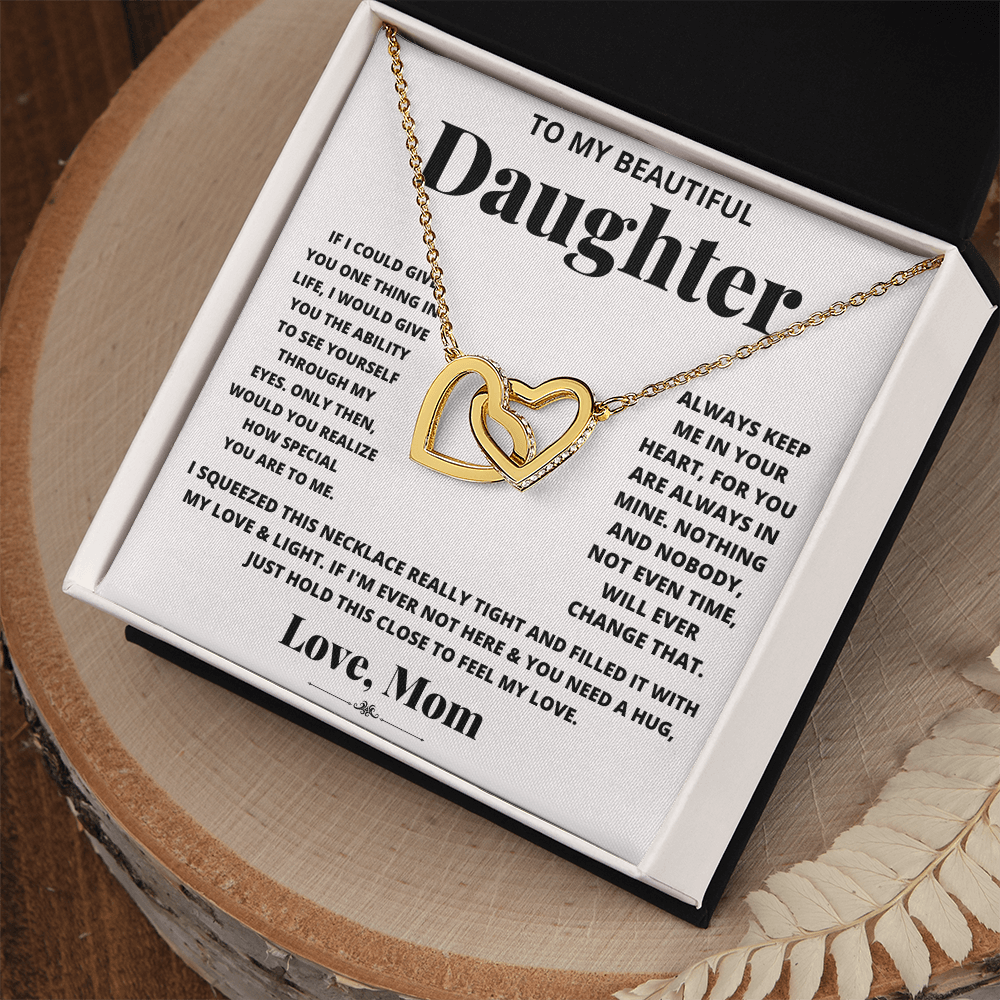 Daughter heart necklace with gold-tone chain and rose-gold heart pendant in box.