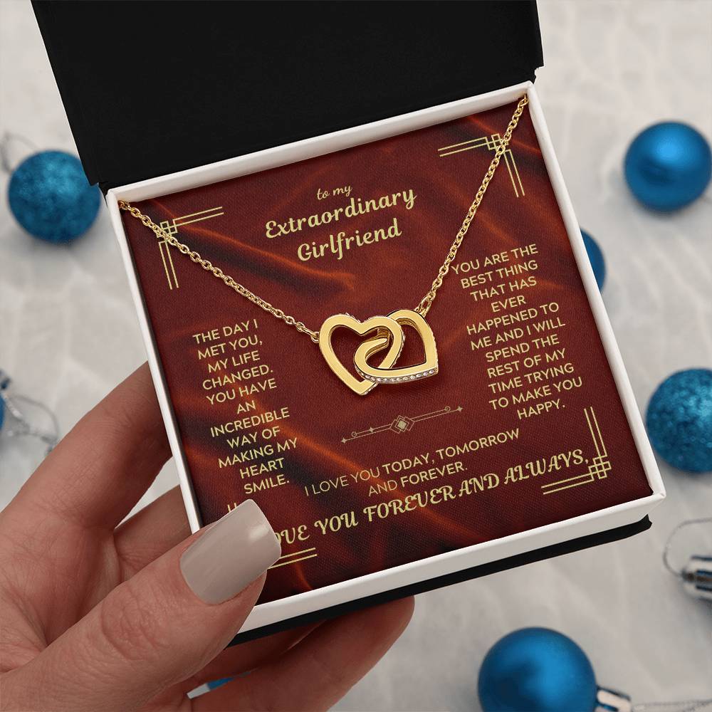Interlocking hearts pendant necklace on a chain, presented in a gift box