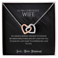 Silver-tone heart pendant necklace displayed in a black-lined gift box.