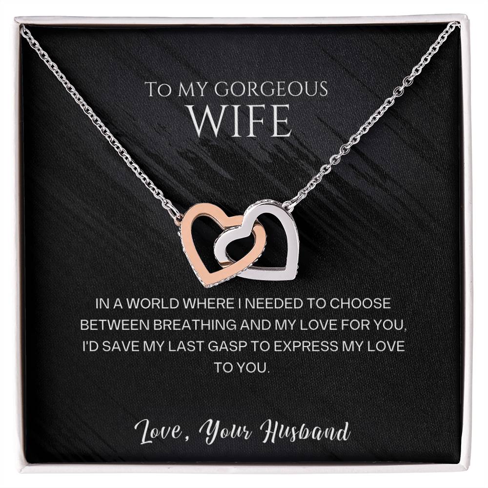 Silver-tone heart pendant necklace displayed in a black-lined gift box.